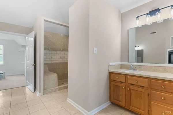 a bathroom with a sink toilet vanity and shower