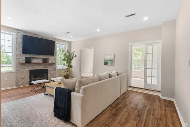 a kitchen with white cabinets and a window