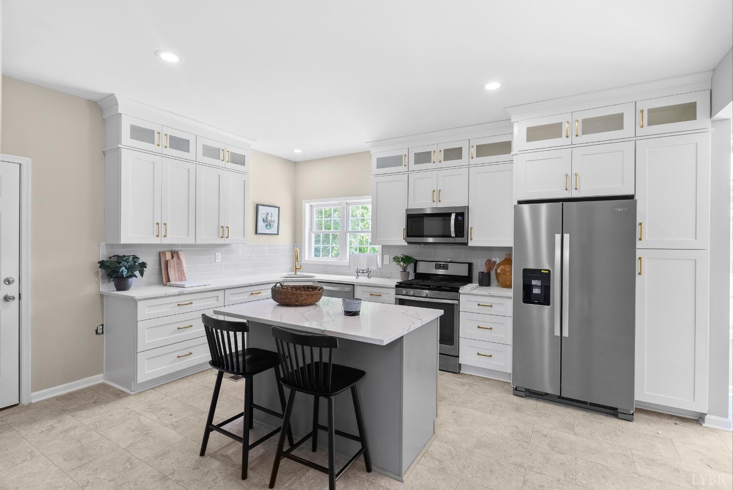 1505 Chestnut Grv Road Appomattox, VA 24522 - Photo 27 of 99 a kitchen with stainless steel appliances granite countertop a dining table chairs refrigerator and microwave