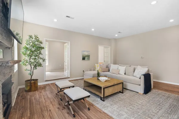 a living room with furniture and a wooden floor