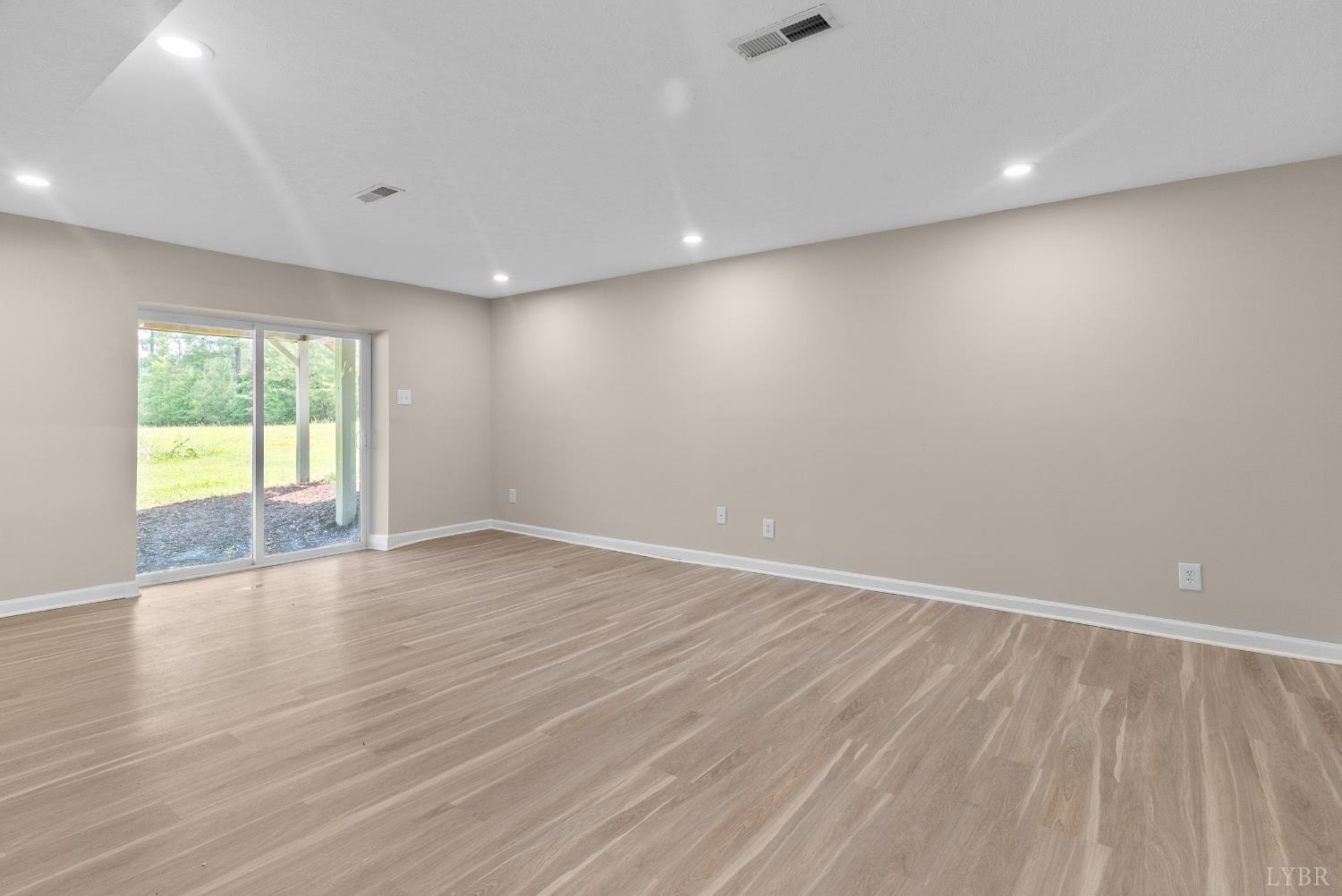 1505 Chestnut Grv Road Appomattox, VA 24522 - Photo 73 of 99 an empty room with wooden floor and windows