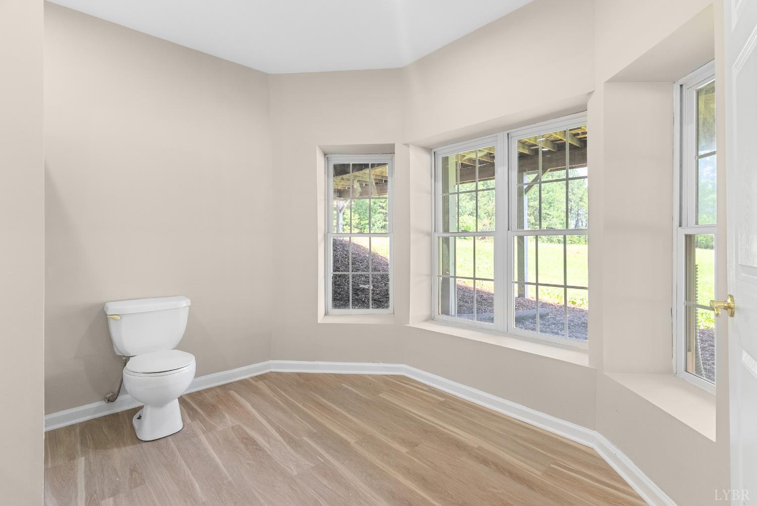 1505 Chestnut Grv Road Appomattox, VA 24522 - Photo 75 of 99 a bathroom with a toilet sink and a large mirror next to a window