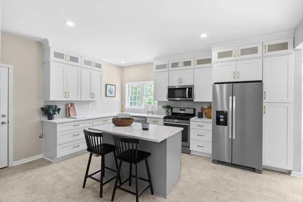 a dining room with furniture a chandelier and wooden floor