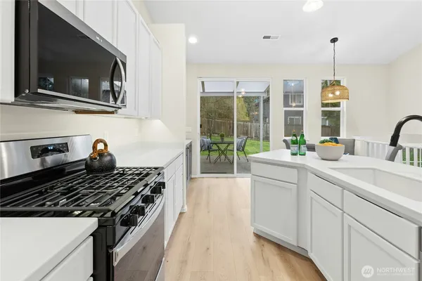 a kitchen with a stove and a sink