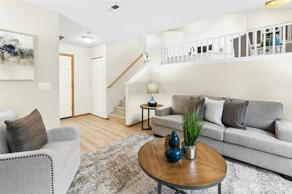 a living room with furniture and a dining table