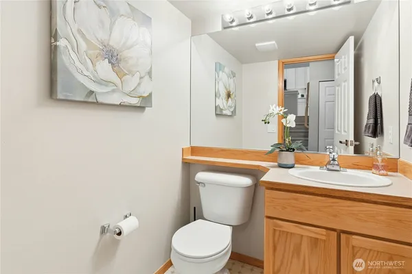 a bathroom with a toilet sink and mirror