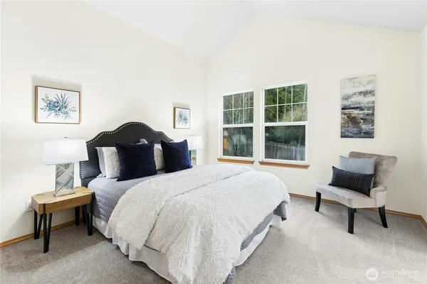 a bedroom with a bed and a window
