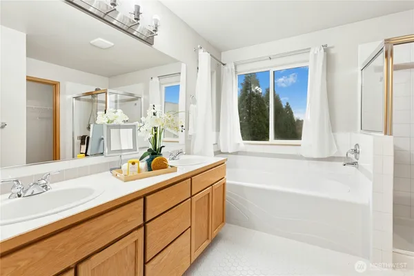 a bathroom with a tub sink and mirror