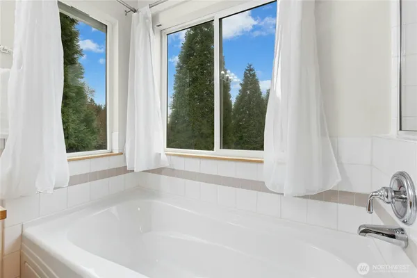a white bath tub sitting in front of a bathroom