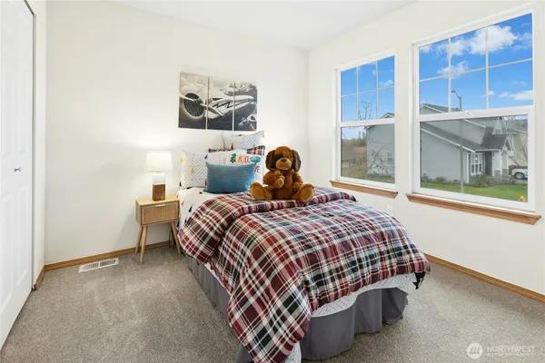 a bedroom with a bed and window