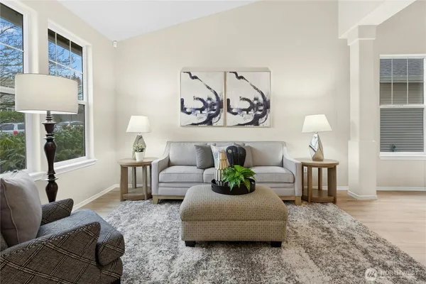 a living room with furniture and a lamp