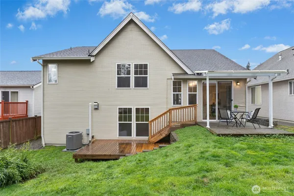 a view of a house with a yard and sitting area