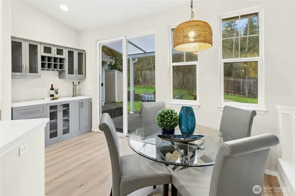 a dining room with furniture window and wooden floor