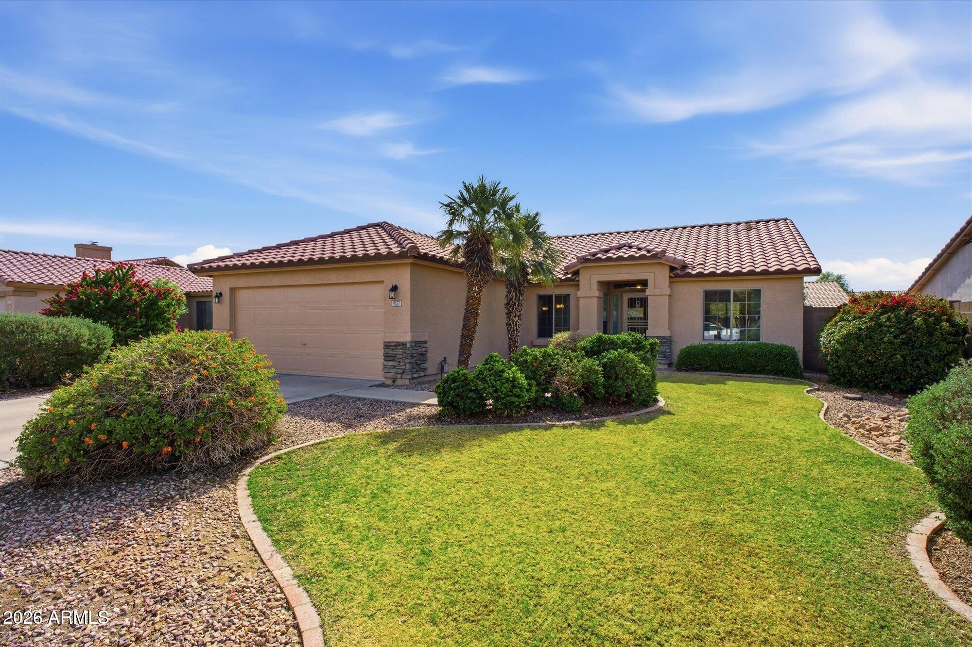 9327 West Mountain View Road Peoria, AZ 85345 - Photo 1 of 30 a front view of a house with garden