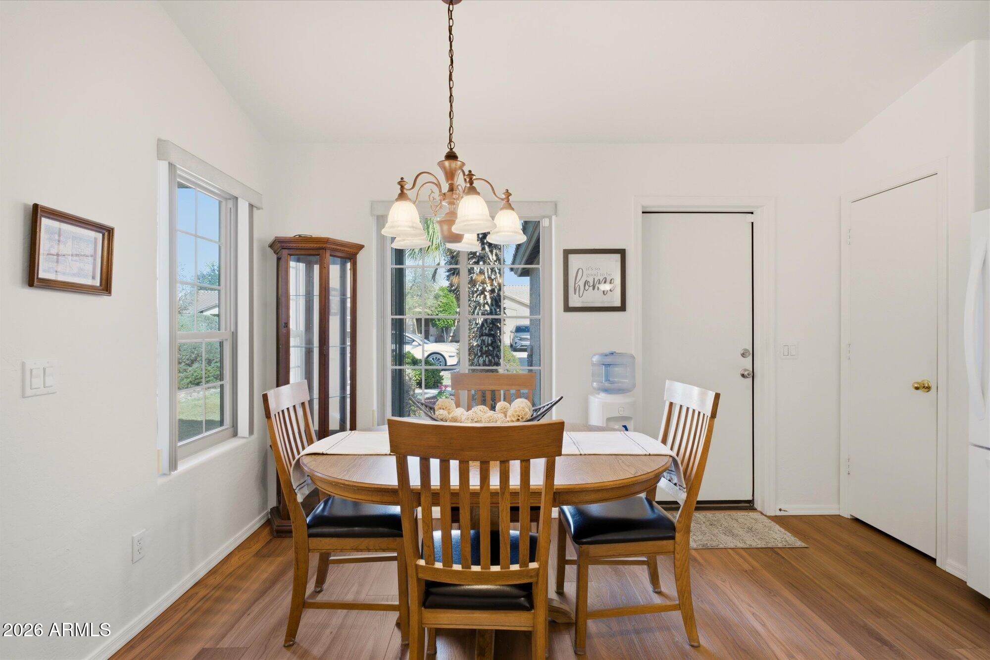 9327 West Mountain View Road Peoria, AZ 85345 - Photo 10 of 30 a view of a dining room with furniture window and wooden floor