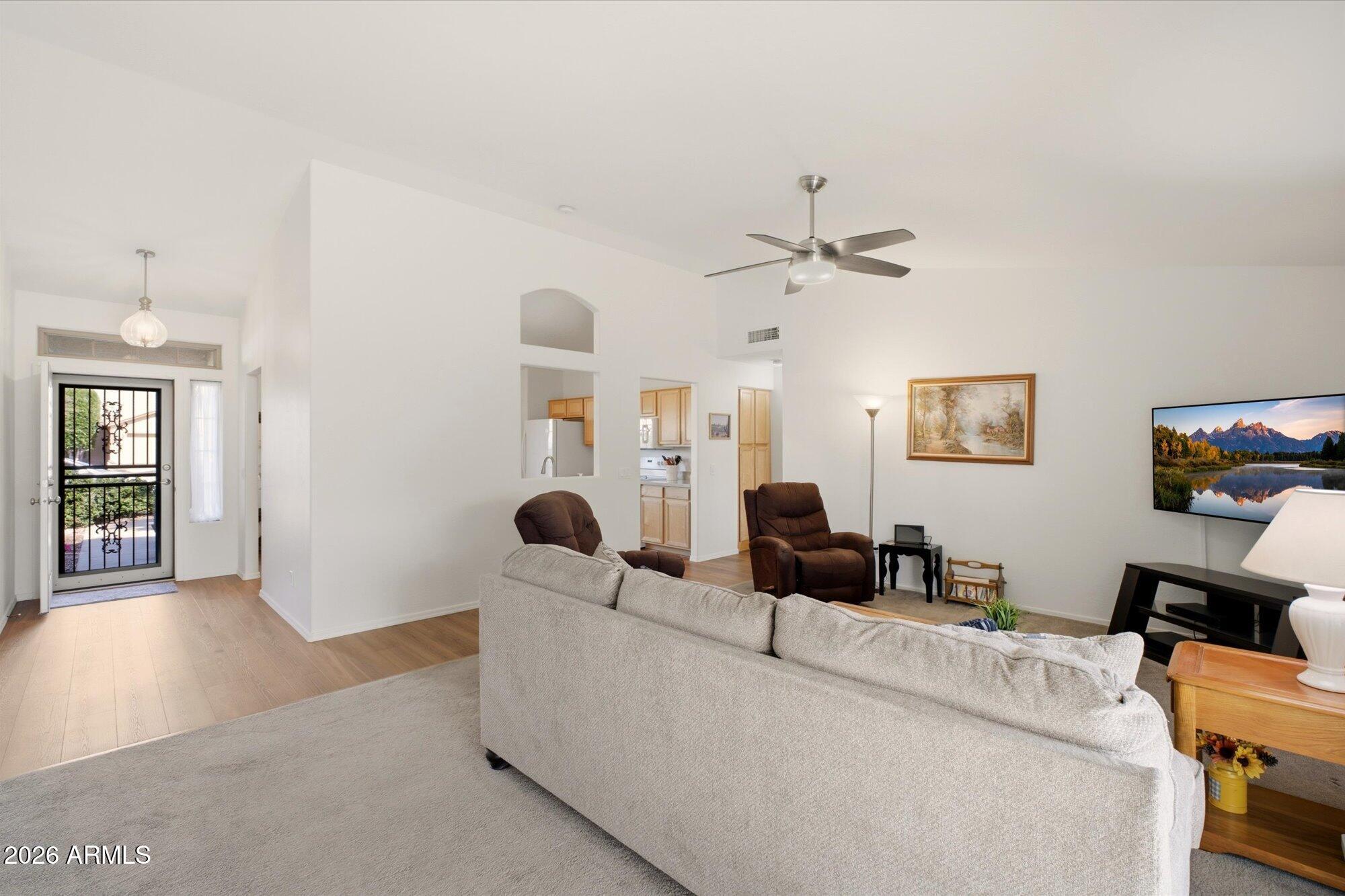 9327 West Mountain View Road Peoria, AZ 85345 - Photo 14 of 30 a living room with furniture and a chandelier