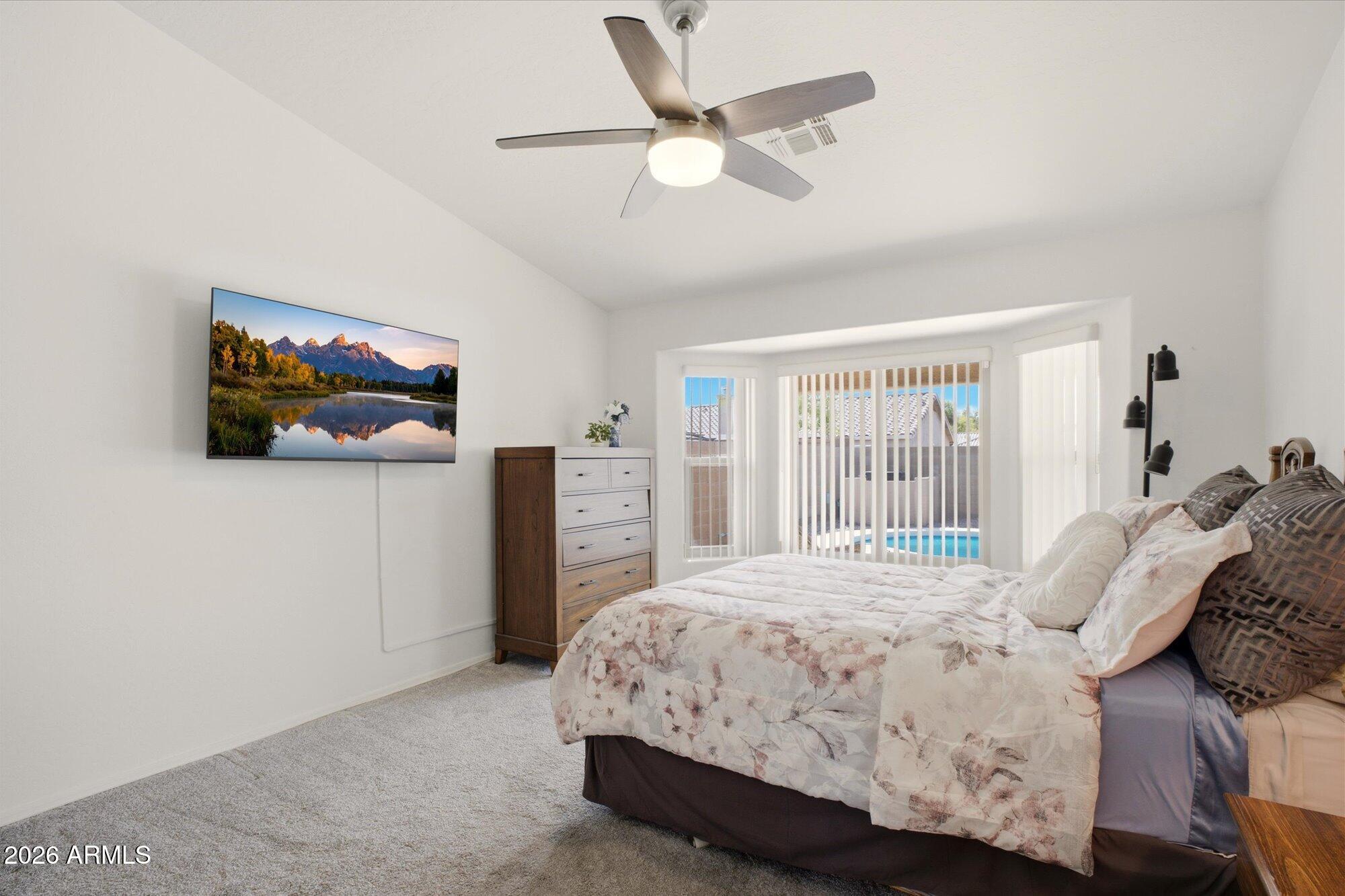 9327 West Mountain View Road Peoria, AZ 85345 - Photo 15 of 30 a bedroom with a balcony a bed and a flat screen tv