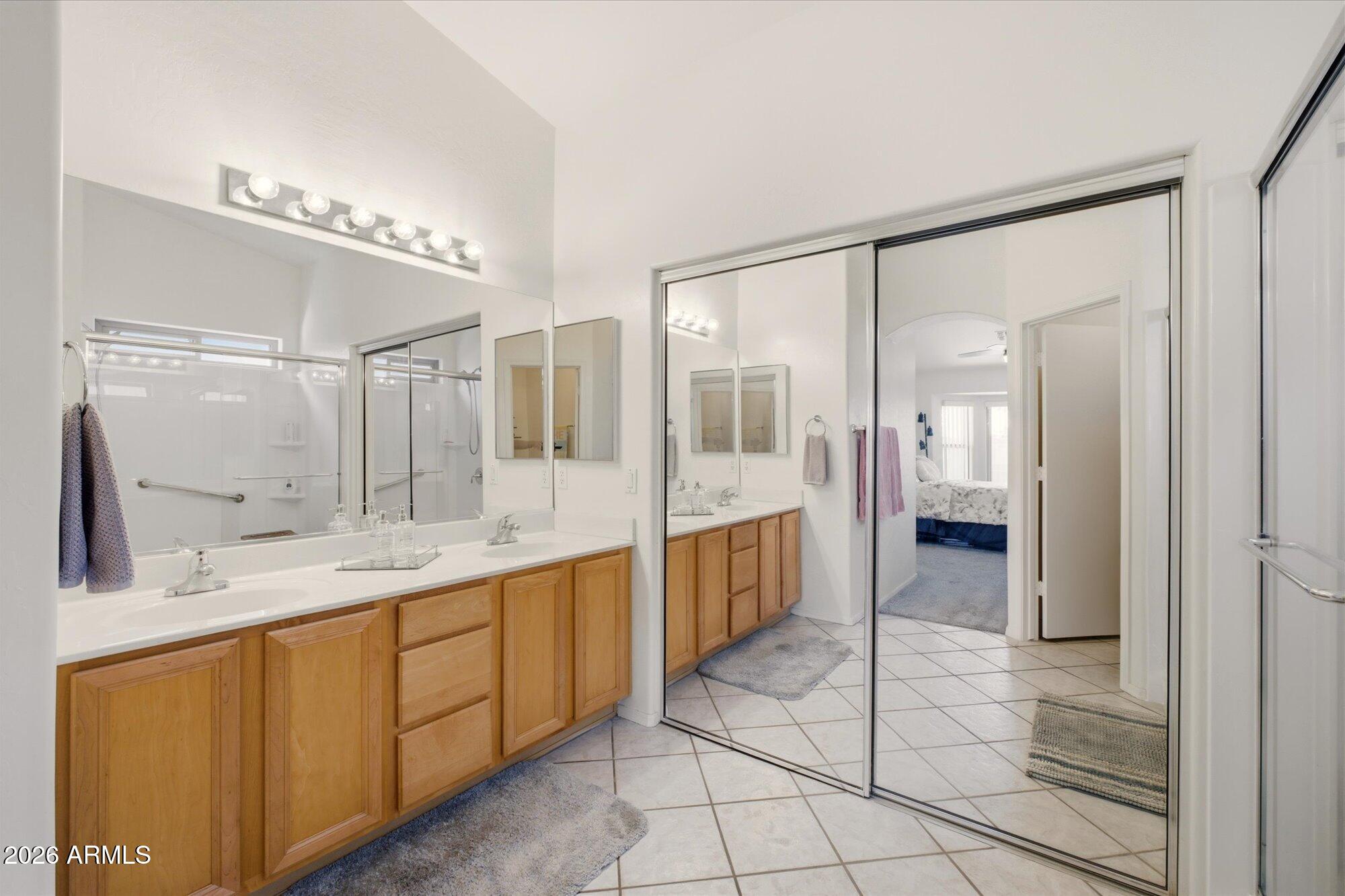 9327 West Mountain View Road Peoria, AZ 85345 - Photo 17 of 30 a large bathroom with a double vanity sink and a mirror