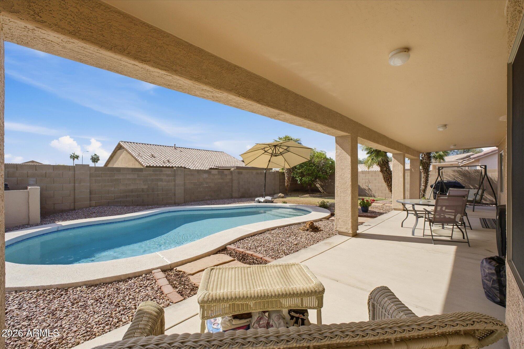 9327 West Mountain View Road Peoria, AZ 85345 - Photo 19 of 30 a view of a swimming pool with an outdoor seating