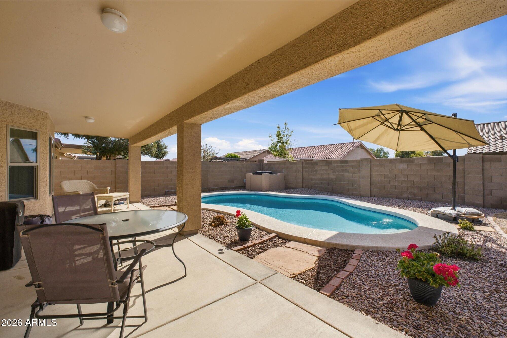 9327 West Mountain View Road Peoria, AZ 85345 - Photo 24 of 30 a view of a chairs and table in backyard