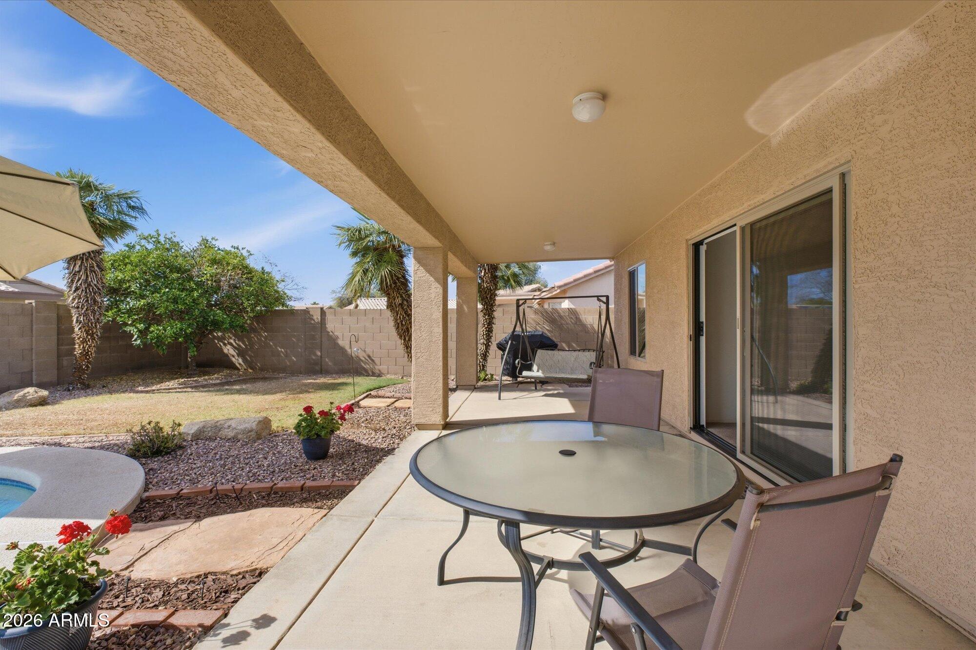 9327 West Mountain View Road Peoria, AZ 85345 - Photo 25 of 30 a backyard of a house with table and chairs
