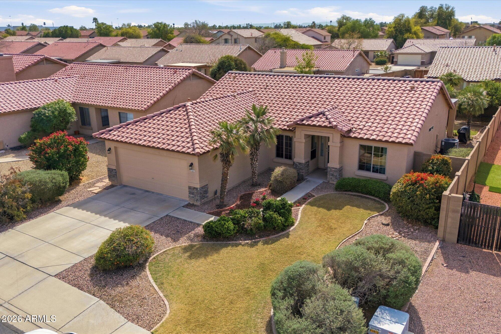 9327 West Mountain View Road Peoria, AZ 85345 - Photo 2 of 30 aerial view of a house with a yard and potted plants