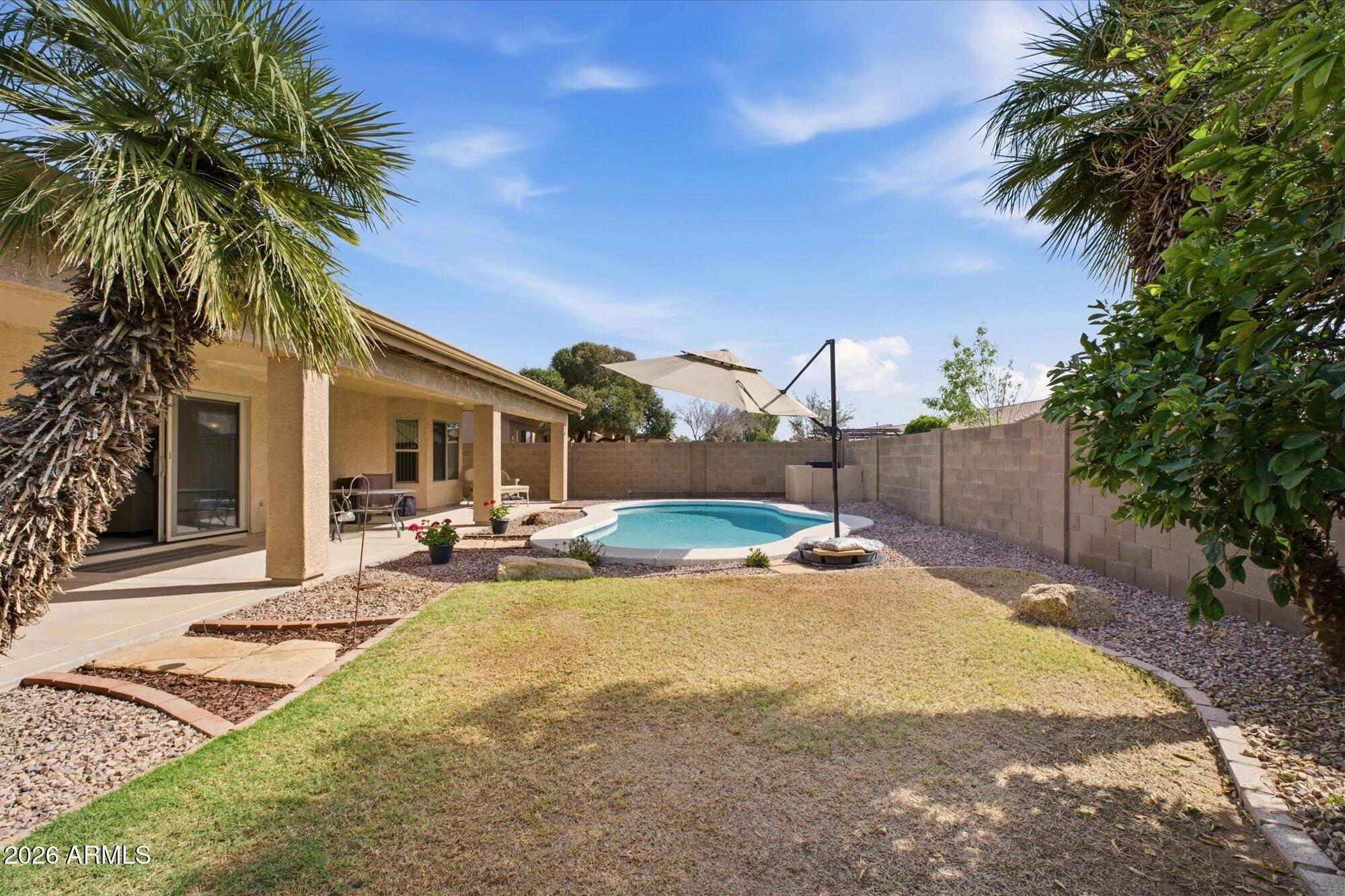 9327 West Mountain View Road Peoria, AZ 85345 - Photo 5 of 30 a view of a house with backyard and sitting area