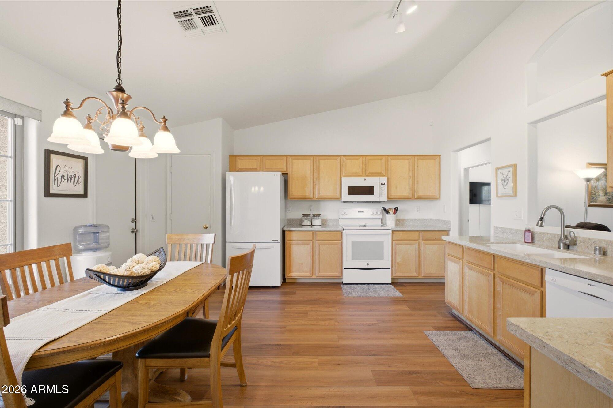 9327 West Mountain View Road Peoria, AZ 85345 - Photo 6 of 30 a large kitchen with a table and chairs