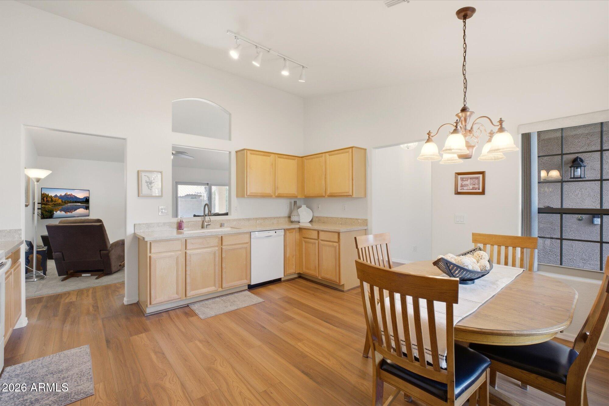 9327 West Mountain View Road Peoria, AZ 85345 - Photo 7 of 30 a kitchen that has a table chairs in it and wooden floors