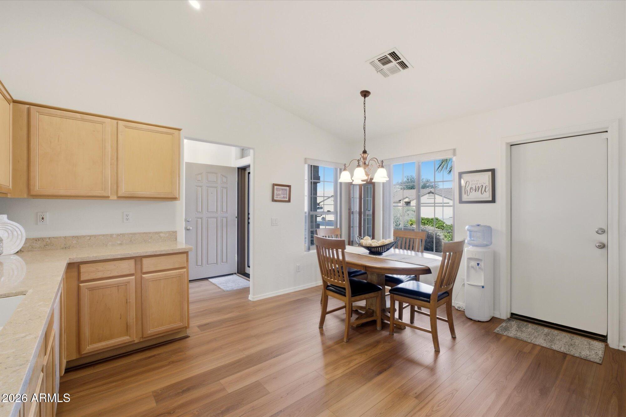 9327 West Mountain View Road Peoria, AZ 85345 - Photo 8 of 30 a view of a dining room with furniture window and wooden floor