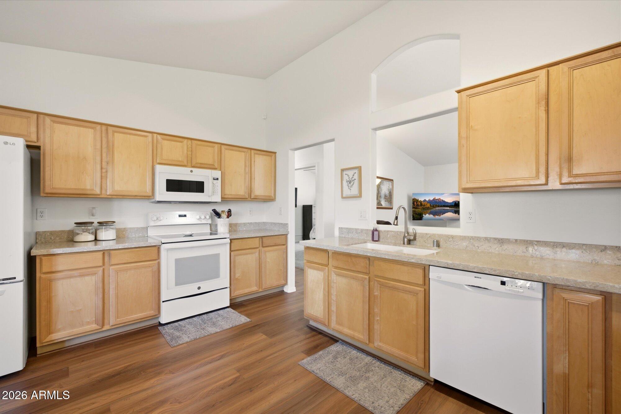 9327 West Mountain View Road Peoria, AZ 85345 - Photo 9 of 30 a kitchen with white cabinets sink and stainless steel appliances