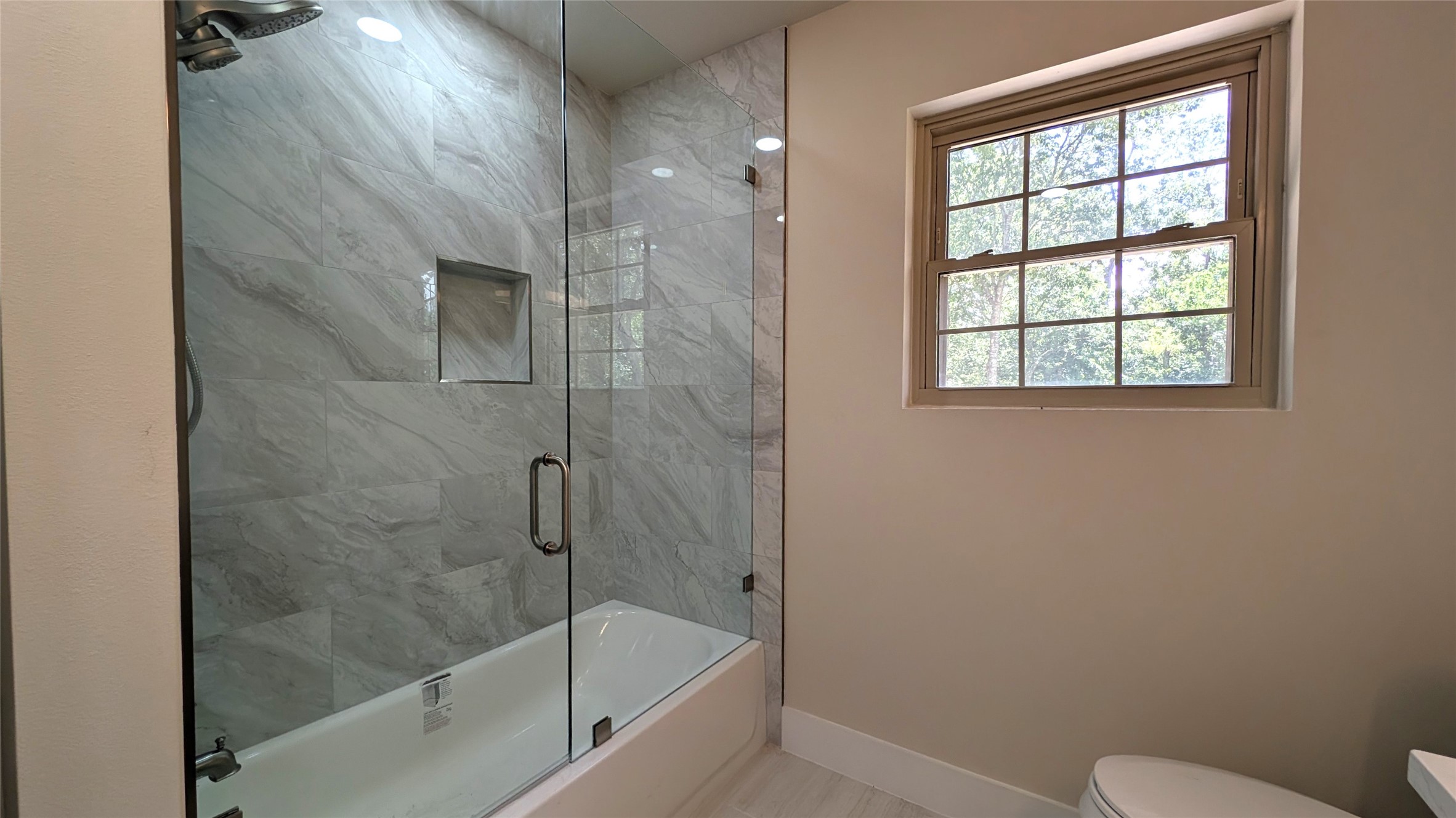11811 Sleepy Hollow Road Manchaca, TX 78652 - Photo 23 of 31 a bathroom with a granite countertop bathtub next to a window