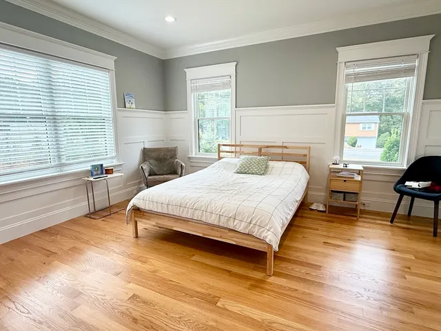 a spacious bedroom with a bed and a window