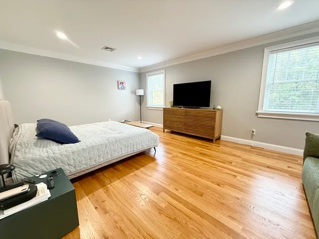 a bedroom with a bed and flat screen tv