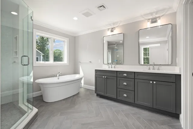 a spacious bathroom with a tub sink mirror and window