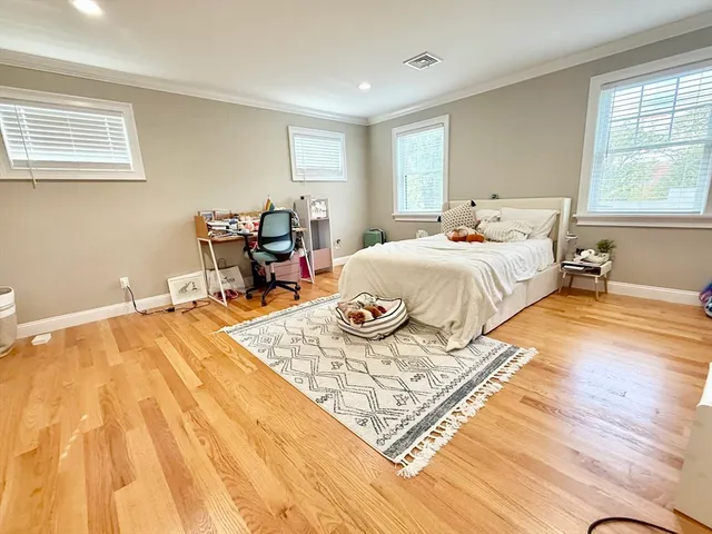 a spacious bedroom with a bed a table and chair
