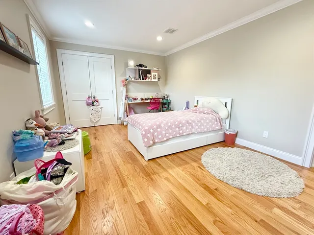 a bedroom with a bed and a dresser