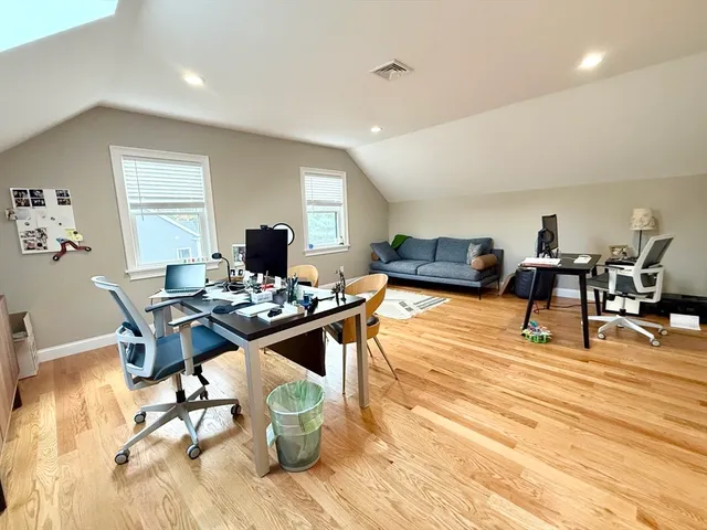 a workspace with furniture and wooden floor