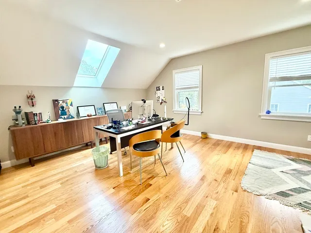 a room with a bed and a wooden floor