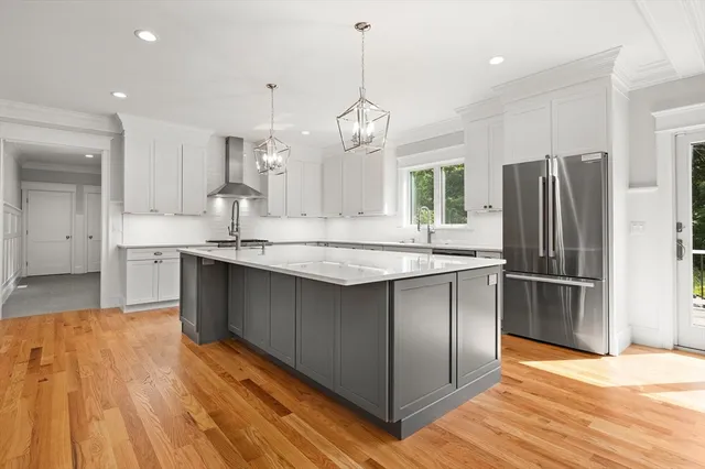 a kitchen with kitchen island granite countertop a sink cabinets and stainless steel appliances