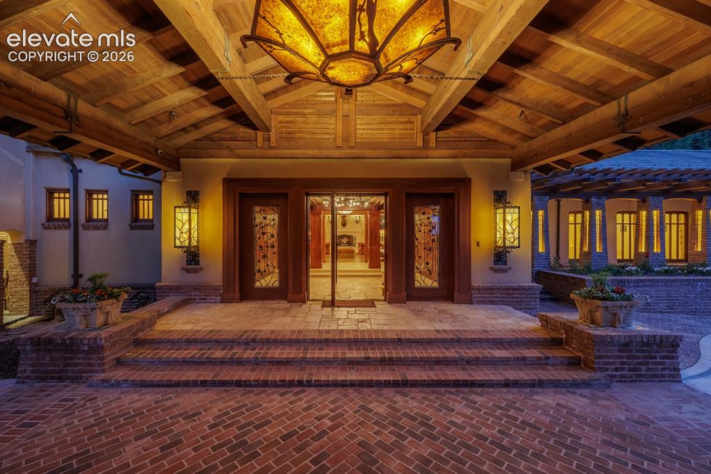 4530 Governors Point Colorado Springs, CO 80906 - Photo 6 of 49 Custom chandelier drops from the porte-cochere showcasing New Mexican blacksmith artisan Robb Gunther. Old growth redwood timbers used on the exterior.