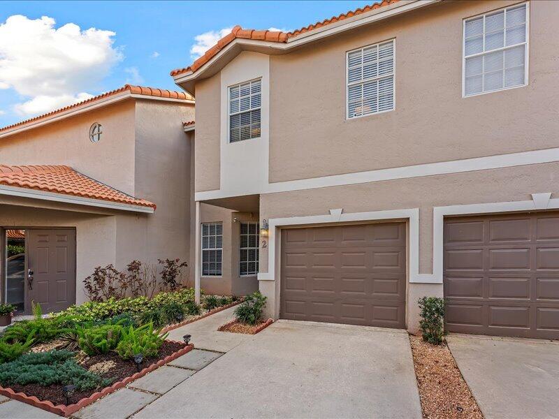 20970 Via Alamanda Boca Raton, FL 33428 - Photo 1 of 51 a front view of a house with garden