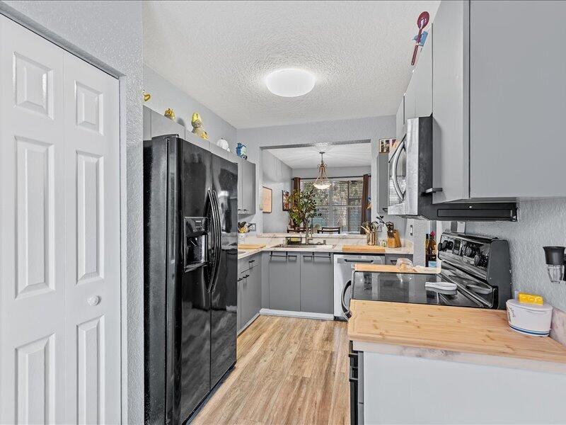 20970 Via Alamanda Boca Raton, FL 33428 - Photo 6 of 51 a kitchen with refrigerator and cabinets