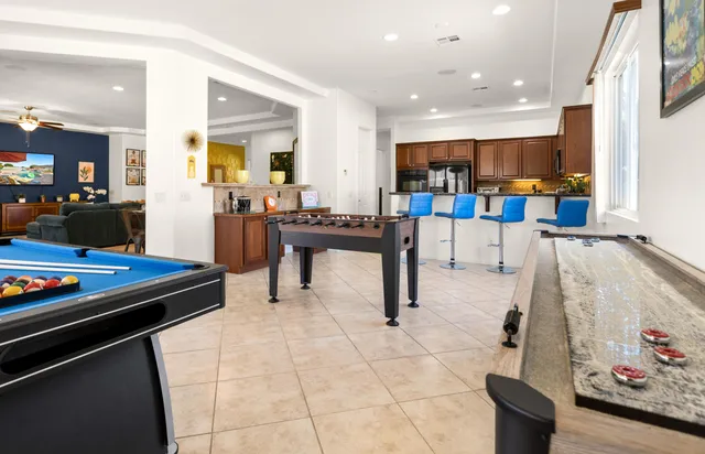 a living room with furniture and kitchen view