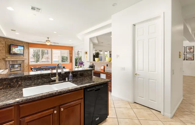 a kitchen with granite countertop a sink and a counter top space
