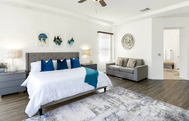 a bedroom with a bed and couch