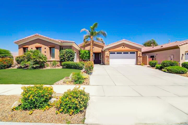 43760 Spiaggia Place Indio, CA 92203 - Photo 2 of 38 a front view of a house with a yard