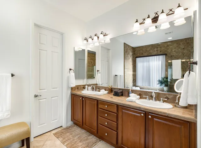 a bathroom with a double vanity sink and a mirror