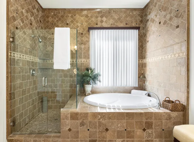 a bathroom with a granite countertop sink a toilet and shower