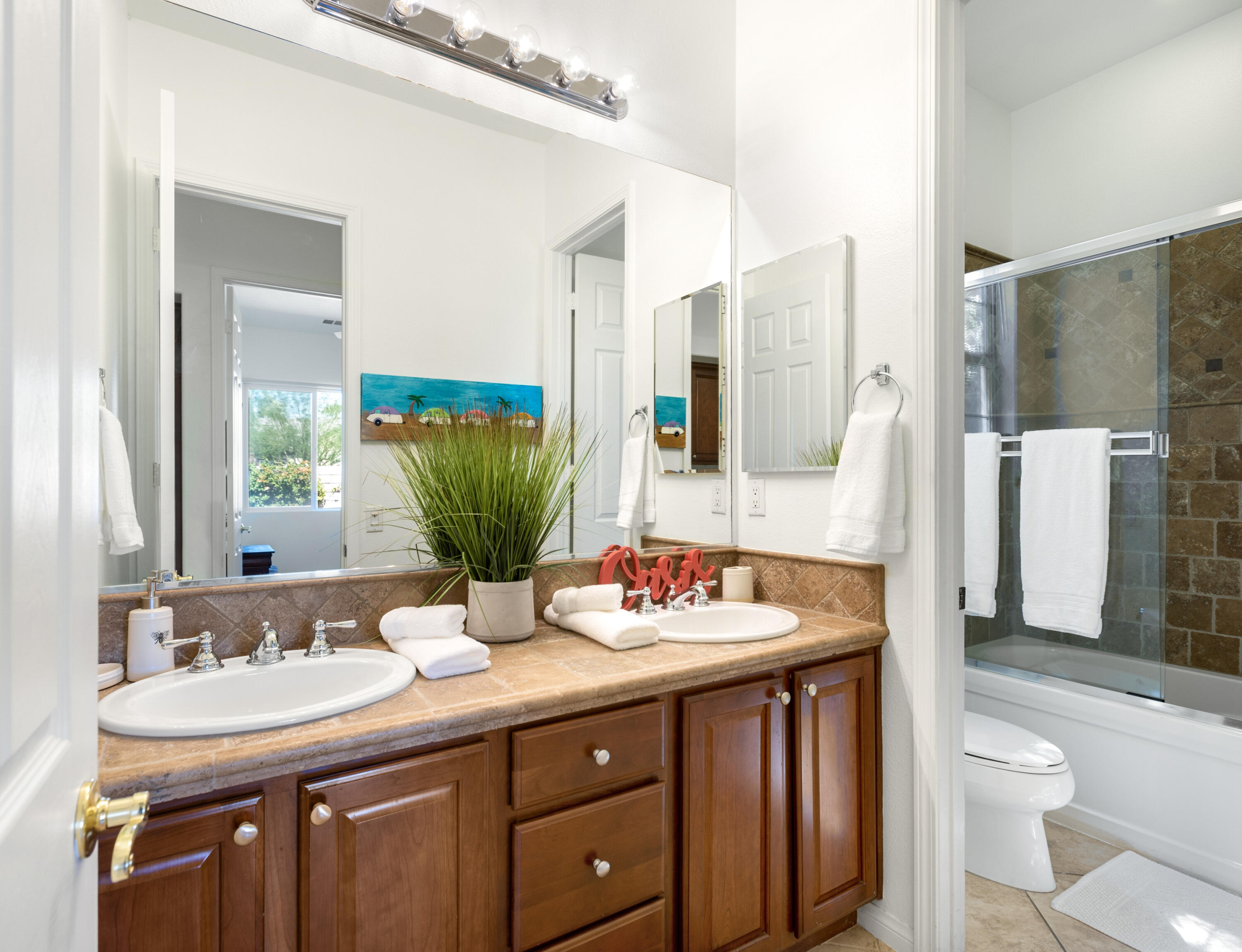 43760 Spiaggia Place Indio, CA 92203 - Photo 27 of 38 a bathroom with a double vanity sink toilet and shower